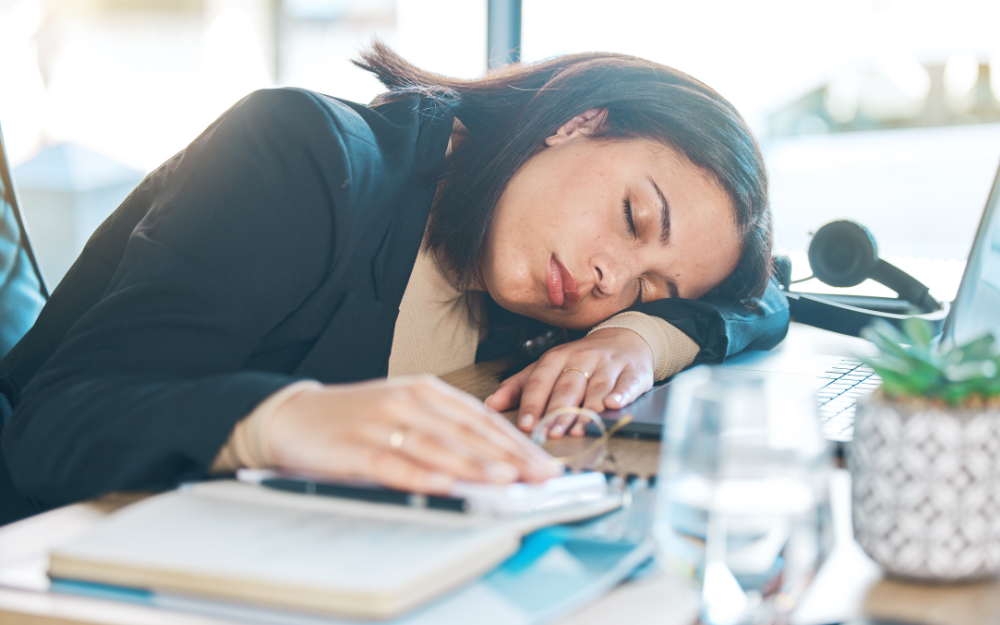 woman with narcolepsy asleep at her desk